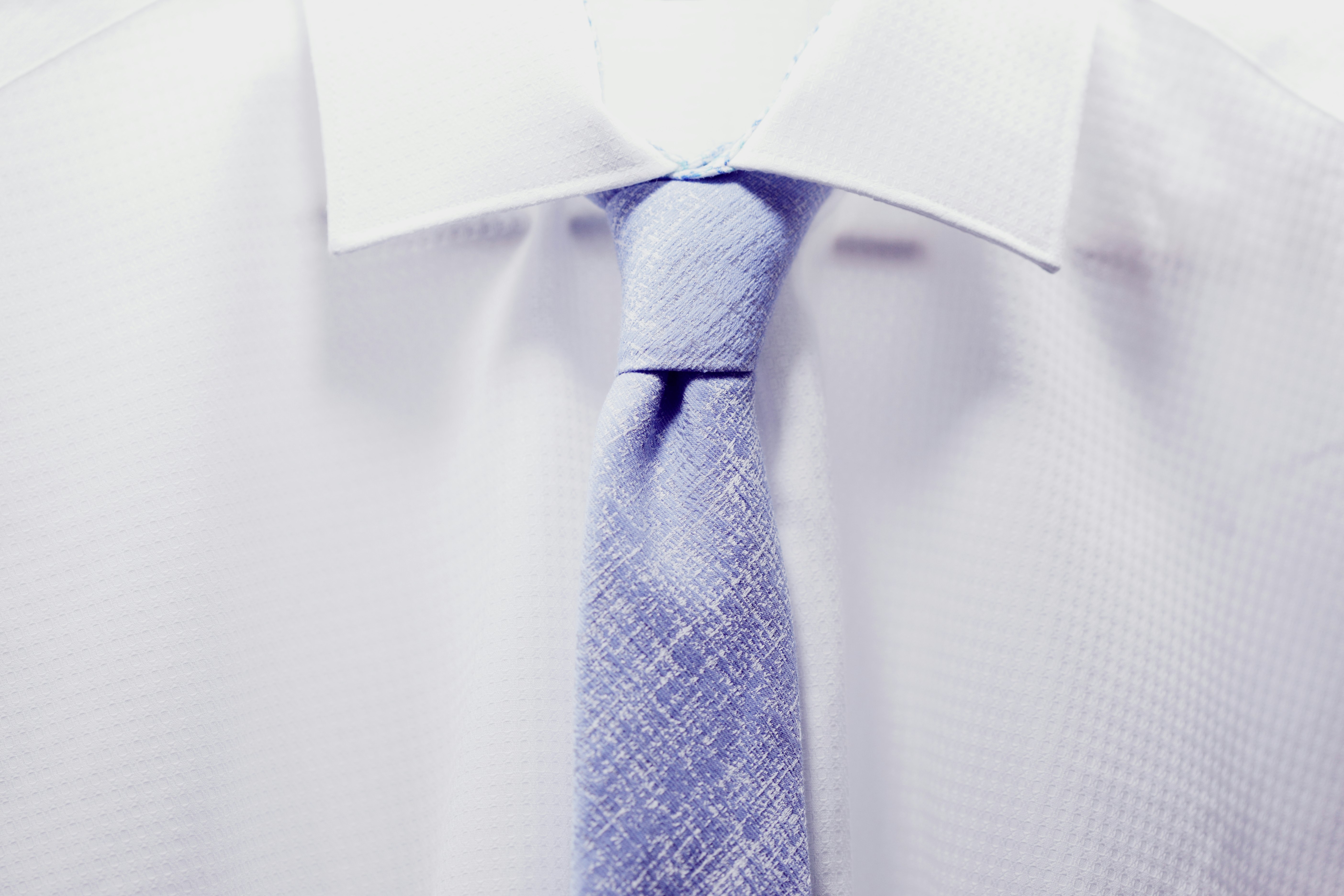 close up photo white collared shirt with blue necktie